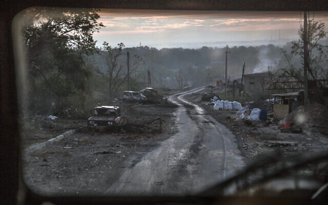 The gutted remains of cars sit along a road during heavy fighting at the front line in Severodonetsk in the Luhansk region of Ukraine, June 8, 2022. (Oleksandr Ratushniak/AP)