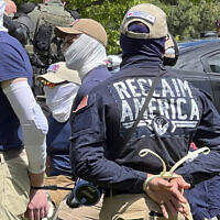 Authorities arrest members of the white supremacist group Patriot Front near an Idaho pride event, June 11, 2022, after they were found packed into the back of a U-Haul truck with riot gear. (Georji Brown via AP)
