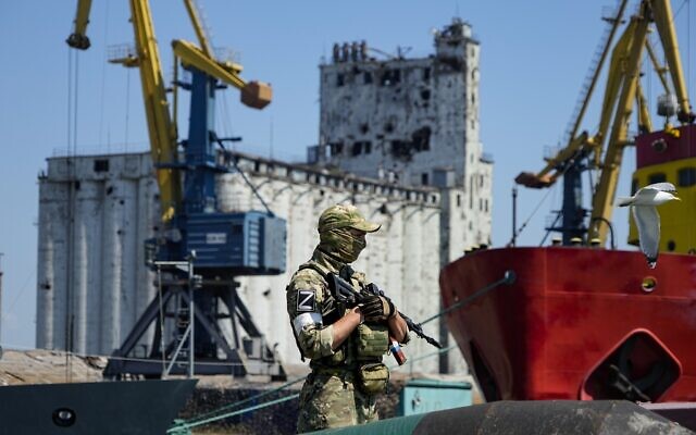 A Russian soldier guards a pier with the grain storage in the background at an area of the Mariupol Sea Port which has recently started its work after heavy fighting in Mariupol, on the territory which is under the Government of the Donetsk People's Republic control, eastern Ukraine, June 12, 2022. This photo was taken during a trip organized by the Russian Ministry of Defense. (AP Photo)