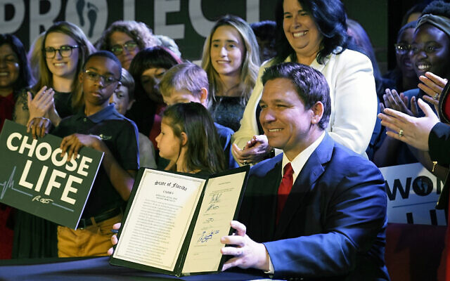 Florida Gov. Ron DeSantis holds up a 15-week abortion ban law after signing it in Kissimmee, Florida, April 14, 2022. (AP/John Raoux, File)