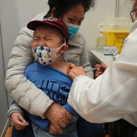 A boy receives a dose of China's Sinovac COVID-19 coronavirus vaccine at a community vaccination center in Hong Kong on Feb. 25, 2022. (AP Photo/Kin Cheung, File)