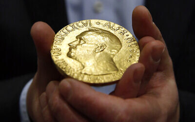 Illustrative: Bidder Ole Bjorn Fausa, of Norway, holds the 1936 Nobel Peace Prize medal in Baltimore, March 27, 2014, the second Nobel Peace Prize ever to come to auction.  (AP Photo/Patrick Semansky, File)