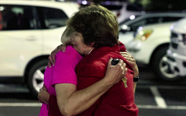 Church members console each other after a shooting at the Saint Stevens Episcopal Church on Thursday, June 16, 2022 in Vestavia, Alabama. (AP Photo/Butch Dill)
