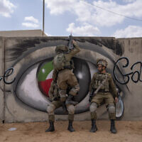 Israeli soldiers climb on a wall as they conduct a mock assault during an urban warfare exercise at an army training facility, in Tzeelim army base, southern Israel, Jan. 24, 2022. (Oded Balilty/AP)