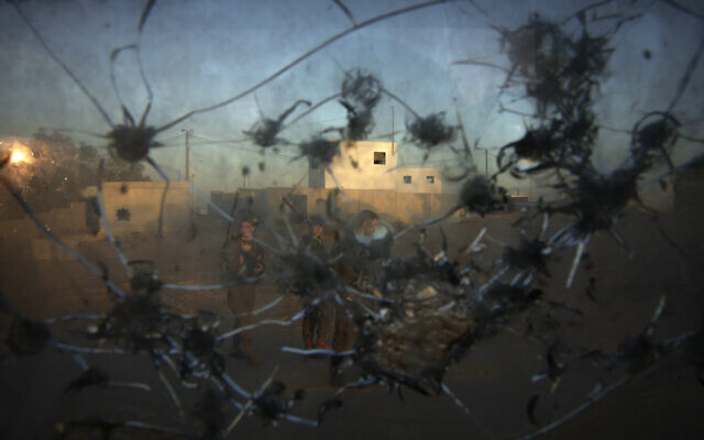 Israeli soldiers are seen trough a broken window of a guard post during an urban warfare exercise at an army training facility at the Tzeelim army base, southern Israel, Nov. 9, 2021. (Oded Balilty/AP)