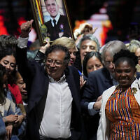 Former rebel Gustavo Petro and his running mate Francia Marquez, celebrate before supporters after winning a runoff presidential election in Bogota, Colombia, Sunday, June 19, 2022. (AP Photo/Fernando Vergara)