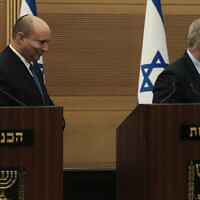 Israeli Prime Minister Naftali Bennett, left, and Foreign Minister Yair Lapid, leave their podiums after a joint statement at the Knesset, announcing the collapse of their coalition, Monday, June 20, 2022. (AP Photo/Maya Alleruzzo)