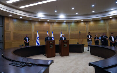 Israeli Prime Minister Naftali Bennett, left, announces the collapse of his coalition government during a joint statement with Foreign Minister Yair Lapid, at the Knesset, June 20, 2022. (AP Photo/Maya Alleruzzo)