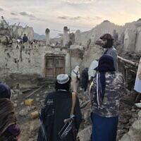Afghans look at destruction caused by an earthquake in the province of Paktika, eastern Afghanistan, June 22, 2022. (Bakhtar News Agency via AP)