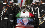 Military personnel stand near the flag-draped coffin of Mohsen Fakhrizadeh, a scientist who was killed on Friday, during a funeral ceremony in Tehran, Iran, November 30, 2020. (Iranian Defense Ministry via AP, File)