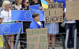 Protestors in support of Ukraine stand with signs and EU flags during a demonstration outside of an EU summit in Brussels, June 23, 2022. (AP Photo/Olivier Matthys)