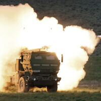 In this file photo from May 23, 2011, a launch truck fires the High Mobility Artillery Rocket System (HIMARS) produced by Lockheed Martin during combat training in the high desert of the Yakima Training Center, Washington. (Tony Overman/The Olympian via AP, File)