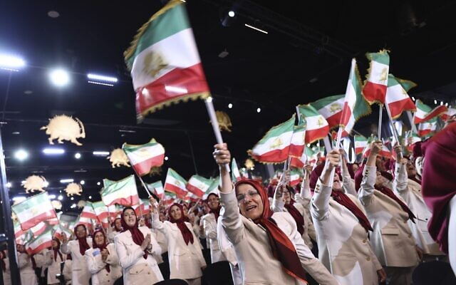 MEK members at the Ashraf 3 camp wave Iranian flags during a speech by former US vice president Mike Pence at the Iranian opposition headquarters in Albania, June 23, 2022. (AP Photo/Franc Zhurda)