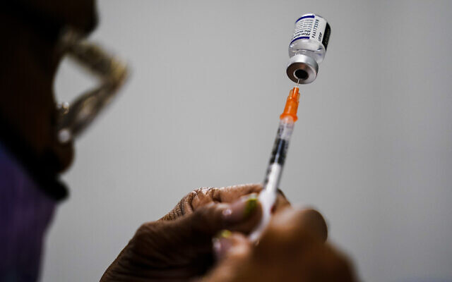 A syringe is prepared with the Pfizer COVID-19 vaccine at a vaccination clinic at the Keystone First Wellness Center in Chester, Pennsylvania, December 15, 2021. (AP Photo/Matt Rourke, File)