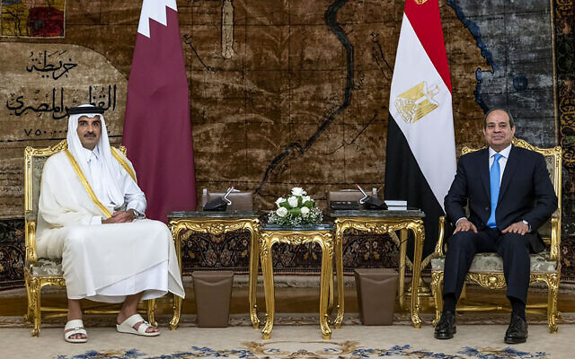 In this photo made available by Qatar News Agency, QNA, Qatari Emir Tamim bin Hamad Al Thani, meets with Egyptian President Abdel-Fattah el-Sissi, at the presidential palace in Cairo, Egypt, June 25, 2022. (QNA via AP)