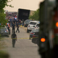 Body bags lie at the scene where a tractor trailer with multiple dead bodies was discovered, in San Antonio, June 27, 2022. (Eric Gay/AP)