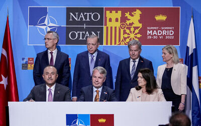 From left to right background: NATO Secretary General Jens Stoltenberg, Turkish President Recep Tayyip Erdogan, Finland's President Sauli Niinisto, Sweden's Prime Minister Magdalena Andersson, Turkish Foreign Minister Mevlut Cavusoglu, Finnish Foreign Minister Pekka Haavisto, and Sweden's Foreign Minister Ann Linde before signing a memorandum in which Turkey agrees to Finland and Sweden's membership of the defense alliance in Madrid, Spain on Tuesday, June 28, 2022. North Atlantic Treaty Organization heads of state will meet for a summit in Madrid from Tuesday through Thursday. (AP/Bernat Armangue)