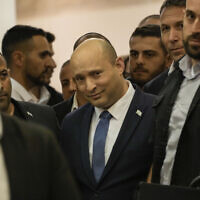 Prime Minister Naftali Bennett arrives to deliver a statement announcing he won't run in the next elections, at the Knesset, June 29, 2022. (AP Photo/Tsafrir Abayov)