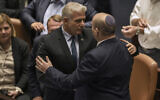 Outoing Prime Minister Naftali Bennett, right, and his interim successor Yair Lapid speak after the passage of a bill to dissolve the Knesset, June 30, 2022. (AP Photo/Ariel Schalit)
