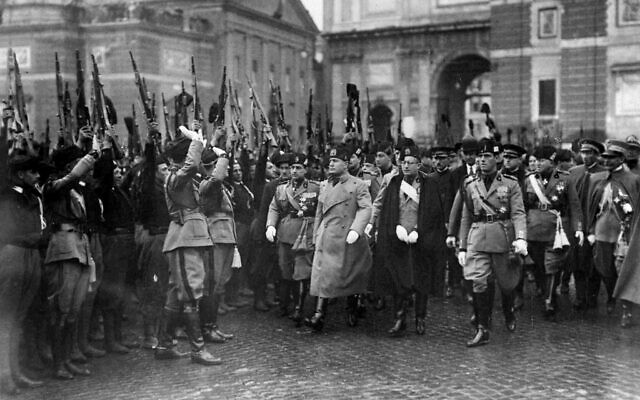 Italian dictator Benito Mussolini, third from right front row, is greeted by some of his troops in the Piazza Popolo, Rome, March 28, 1928, during the celebration of the founding of the Fascist Army nine years prior. (AP Photo)