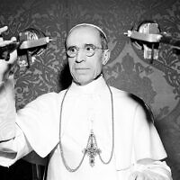 Pope Pius XII appears behind microphones during a radio broadcast from the Vatican in November 1947.  The Pope commended the American people for their efforts to save food for war-torn Europe.  (AP Photo/Luigi Felici)