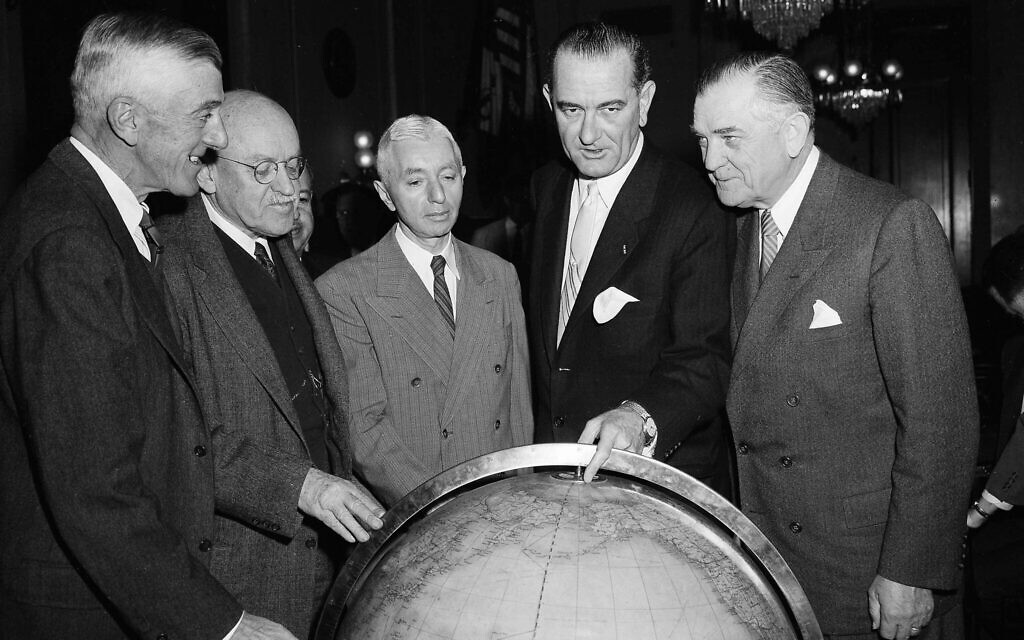 Then-US senator Lyndon Johnson points to the polar region on a globe while posing with Rear Adm. Hyman Rickover, center, and Sen. John Stennis (D-Miss.), right, January 6, 1958. (AP Photo/Henry Griffin)