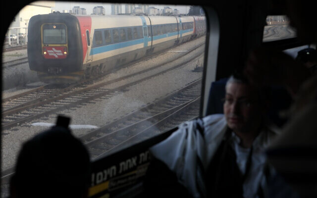 Illustrative: Orthodox Jewish men wear prayer shawls during services on a train, on February 4, 2010. (Yaakov Naumi/Flash90)