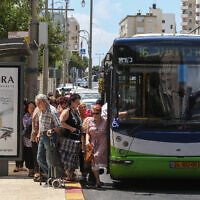 Israelis board a Kavim bus on the main street in the central city of Petah Tikva, June 24, 2015. (Nati Shohat/FLASH90)