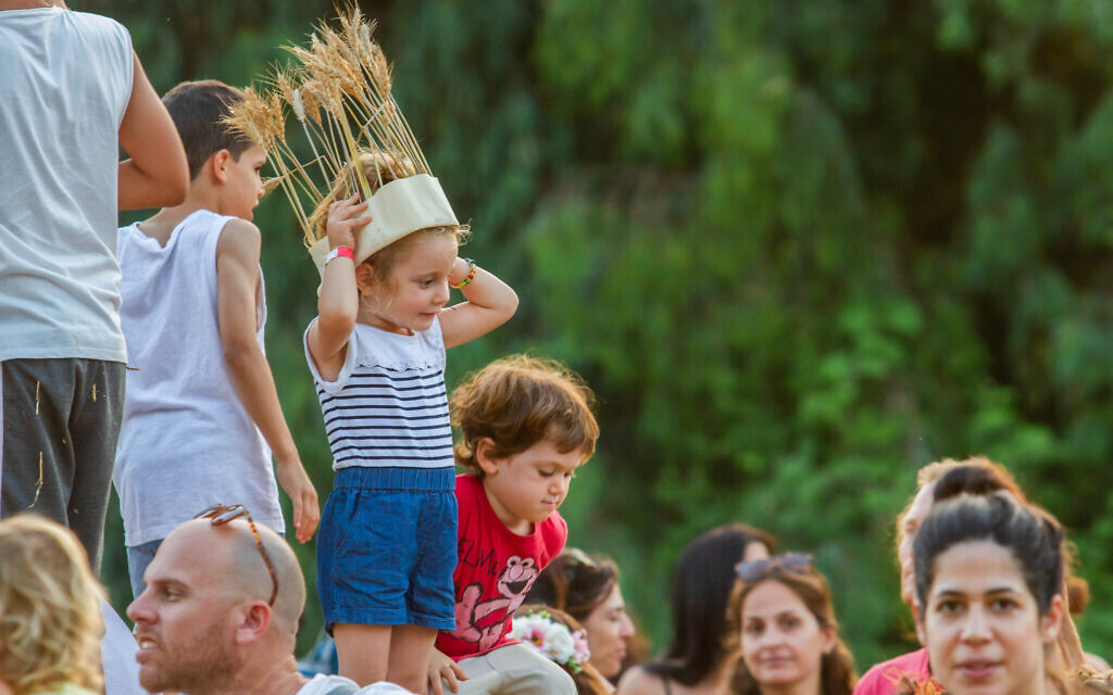 Israelis seen at a celebration for the Jewish holiday of Shavuot in Moshav Kfar Yedidia on June 9, 2019. (Flash90)