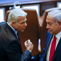 Foreign Minister Yair Lapid and opposition leader Benjamin Netanyahu in the Knesset on November 8, 2021. (Olivier Fitoussi/Flash90)