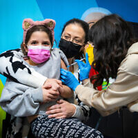 A child receives a COVID vaccine in Jerusalem on December 30, 2021. (Olivier Fitoussi/Flash90)