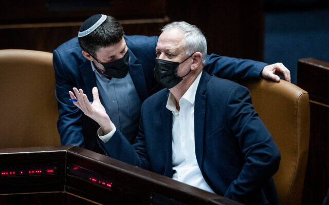 Defense Minister Benny Gantz with MK Bezalel Smotrich during a plenum session at the Knesset, in Jerusalem, on February 28, 2022. (Yonatan Sindel/Flash90)