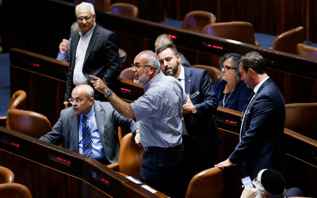 Joint List MK Sami Abou Shehadeh is ejected from the Knesset during a stormy vote to ban the flying of Palestinian flags at state-funded institutions in Jerusalem on June 1, 2022. (Olivier Fitoussi/Flash90)