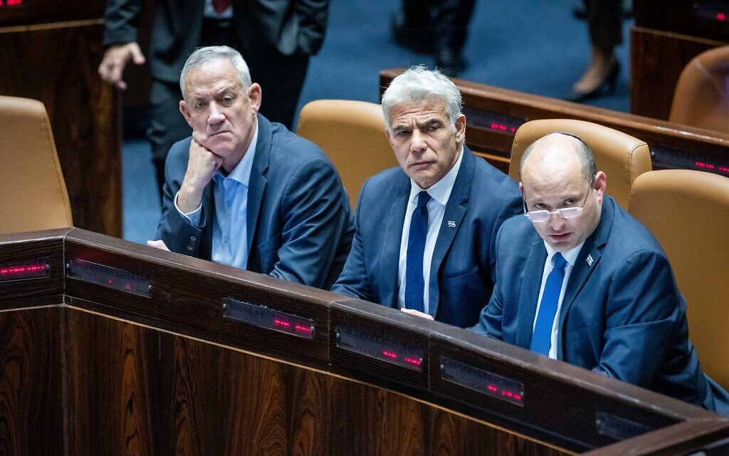 Prime Minister Naftali Bennett (R), Foreign Minister Yair Lapid (C) and Defense Minister Benny Gantz (L) during a Knesset discussion on a bill to renew the application of some Israeli law to settlers, June 6, 2022. (Yonatan Sindel/Flash90)