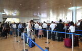 Illustrative: Travelers stand in line to check in at Ben Gurion International Airport, on June 13, 2022. (Yossi Aloni/FLASH90)