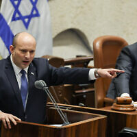 Prime Minister Naftali Bennett addresses the Knesset during a '40 signatures debate' in the plenum hall on June 13, 2022. (Yonatan Sindel/Flash90)