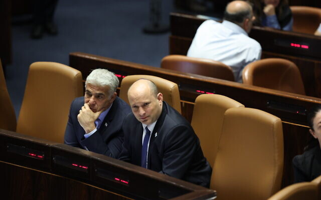 Prime Minister Naftali Bennett, right, and Foreign Minister Alternative Prime Minister Yair Lapid in the Knesset, Jerusalem on June 20, 2022. (Yonatan Sindel/Flash90)