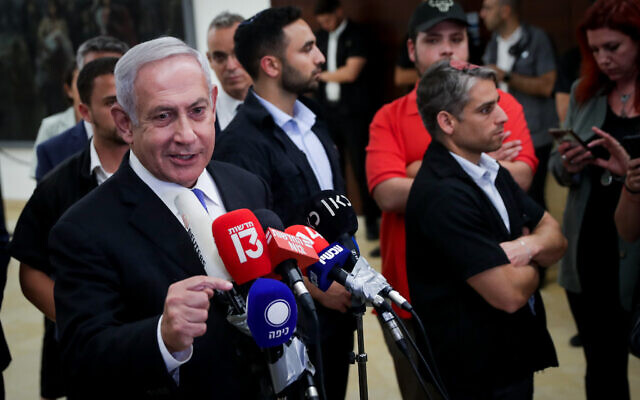 Opposition leader Benjamin Netanyahu hails the collapse of the Bennett-Lapid coalition, at the Knesset in Jerusalem on June 20, 2022. (Yonatan Sindel/Flash90)