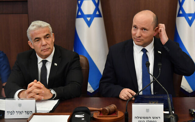 Prime Minister Naftali Bennett leads a cabinet meeting at the Prime Minister's Office in Jerusalem on June 26, 2022. At left is Foreign Minister Yair Lapid (Yoav Dudkevitch/POOL)