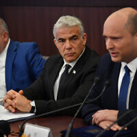 Prime Minister Naftali Bennett, right, sitting alongside Foreign Minister Yair Lapid, center, and Finance Minister Avigdor Liberman, leads a cabinet meeting at the Prime Minister's Office in Jerusalem on June 26, 2022. (Yoav Dudkevitch)