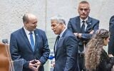 Prime Minister Naftali Bennett and Minister of Foreign Affairs Yair Lapid speak ahead of the first reading of a vote to dissolve the Knesset, on June 27, 2022. (Olivier Fitoussi/Flash90)