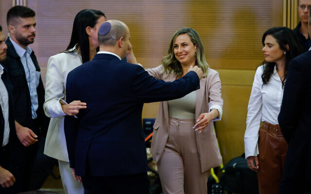 Outgoing Prime Minister Naftali Bennett after a press conference at the Israeli parliament at which he announced he will not be running in the next elections. Ayelet Shaked, the new Yamina party leader, is at right. Stella Weinstein, Yamina's outgoing CEO, is at center, June 29, 2022. (Olivier Fitoussi/Flash90)