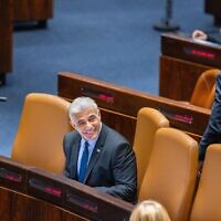 Foreign Minister Yair Lapid, the incoming interim prime minister, sits in the Knesset, during voting to dissolve parliament for new elections, on June 30, 2022. (Olivier Fitoussi/Flash90)