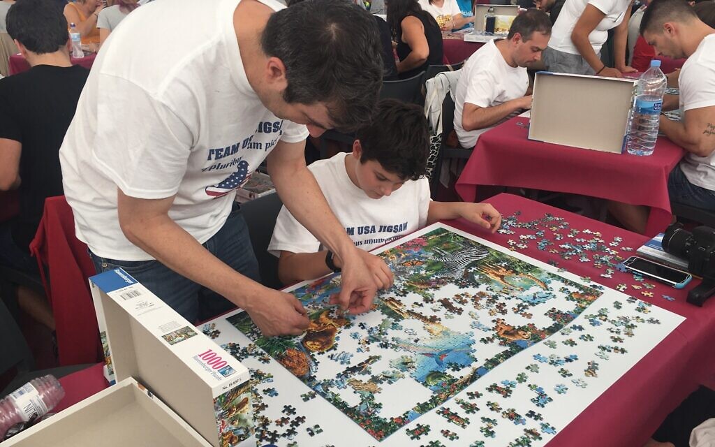 A.J. Jacobs and son working on a jigsaw puzzle at the 2019 World Jigsaw Puzzle Championship in Spain. (Courtesy)