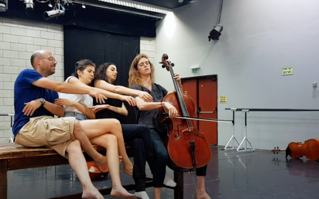 Members of the Revolution Orchestra rehearsing for their latest piece, 'Moods,' to be performed June 12, 2022 at the Tel Aviv opera house (Courtesy Revolution Orchestra YouTube screen shot)