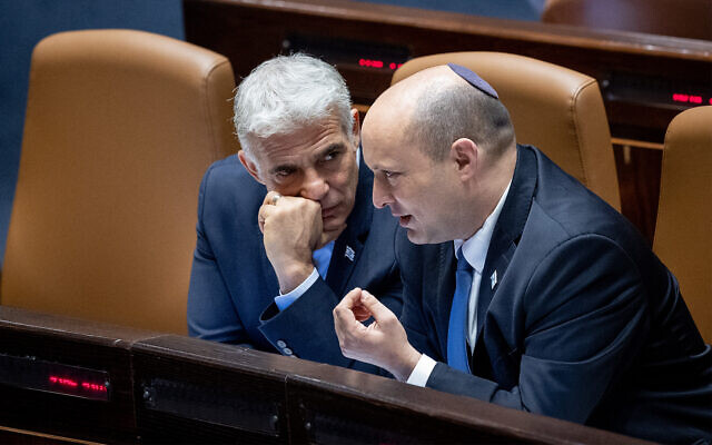 Prime Minister Naftali Bennett and Foreign Minister Yair Lapid in the Knesset,in Jerusalem on June 20, 2022. (Yonatan Sindel/Flash90)