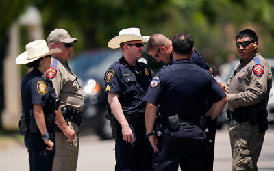 Members of law enforcement gather outside the funeral service for Jacklyn Cazares, a victim of the Uvalde shooting, at Sacred Heart Catholic Church, June 3, 2022, in Uvalde, Texas. (AP Photo/Eric Gay)