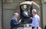 Prime Minister Naftali Bennett (left) is shown a new laser-based air-defense system at a Rafael weapons manufacturer complex in Israel, on May 31, 2022. (Amos Ben Gershom/GPO)