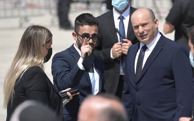 Matan Sidi (Center), departing spokesman for Prime Minister Naftali Bennett (R), in an undated photo. (Government Press Office)
