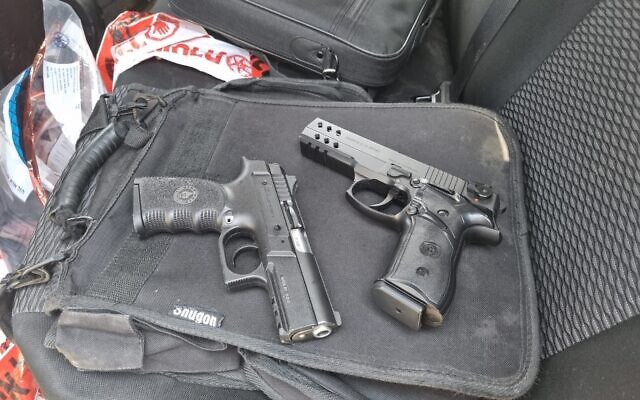 Two handguns seized by IDF troops from a group of Palestinians and Arab Israelis near the city of Umm al-Fahm, June 16, 2022. (Israel Police)